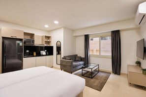 Superior Studio, Courtyard View | Living area | 55-inch Smart TV with digital channels, Netflix, streaming services - Brassbell New Cairo (New Cairo)