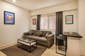 Apartment, 1 Bedroom, Courtyard View | Living area | 55-inch Smart TV with digital channels, Netflix, streaming services - Brassbell New Cairo  (New Cairo)