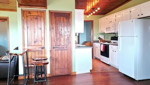 A kitchen with wooden cabinets, a white refrigerator, and a wooden ceiling. - Home, Hooks & Heart: Anglers Paradise Family-Friendly Bay House Marina 2 Blocks (Corpus Christi)