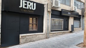 A building with a black facade and the name "JERU Caps Hotel" displayed prominently. - Jeru Caps CityCenter (Jerusalem)
