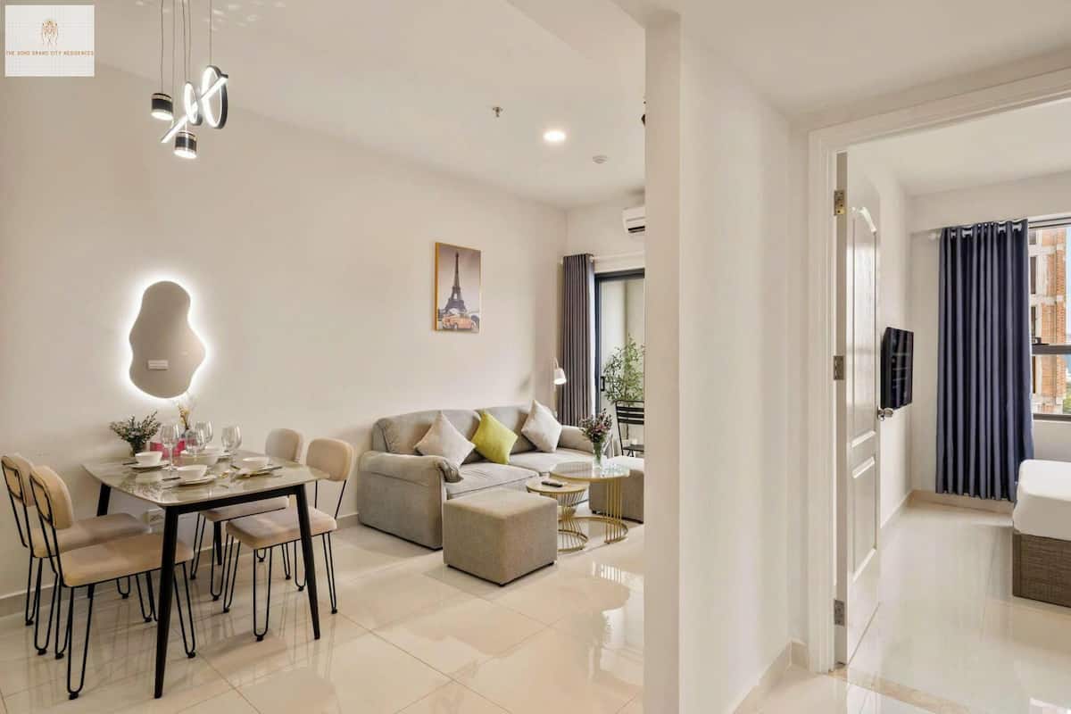 A modern living room with a dining area, a sofa set, and a coffee table.
