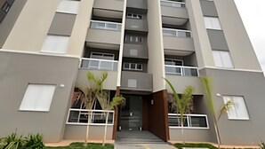 A multi-story residential building with a central entrance, balconies, and a flat roof. - Mel Prime Executive Loft Extrema MG (Extrema)