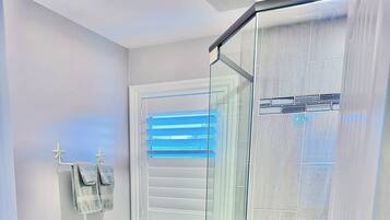 Shower, hair dryer, soap, toilet paper