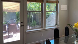 A room with a dining table, chairs, a window with blinds, and a view of the backyard. - Comfort and calm in Ashland (Ashland)