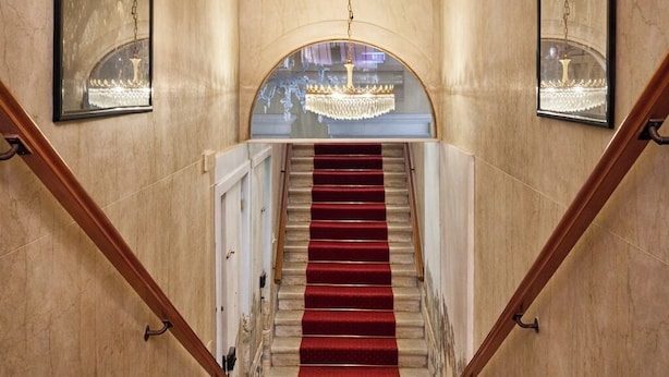 A grand staircase with a red carpet, marble walls, and a chandelier. - PALAZZO MALIPIERO TREVISAN - LE TRE DIMORE D'EPOCA (Venice)