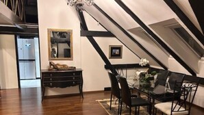 A dining area with a glass table, black chairs, and a patterned rug. - Zagreb Downtown Luxury Stay – 5th Element (Zagreb)