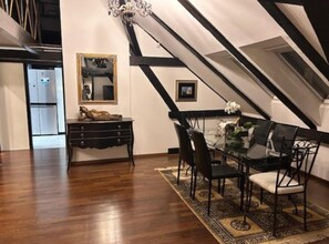 A dining area with a glass table, black chairs, and a patterned rug. - Zagreb Downtown Luxury Stay – 5th Element (Zagreb)