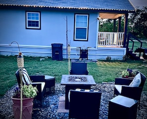A patio area with outdoor furniture, a grill, and a house in the background. - Luxury Micro Retreat| Spa Amenities|Fire Pit|Pet Yard (Collin County)