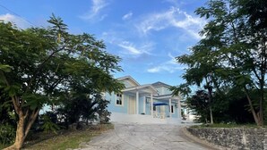 A two-story house with a covered porch and a paved driveway. - Secluded Contemporary 2BR 2BA Suite (Dundas Town)