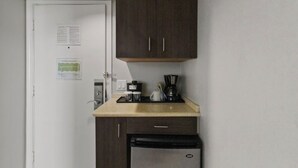 A compact kitchenette with a coffee maker, a small refrigerator, and a microwave. - Ocean & Diamond Head-view studio in Waikiki (Honolulu)