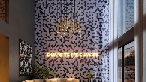 A modern lobby with a geometric patterned wall, a neon sign, a sofa, a coffee table, and a cowhide rug. - Morse Residencial Flipchave MOR000 (Joinville)