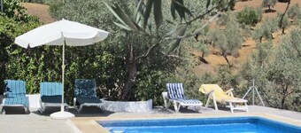 Andalusian traditional country house with pool, surrounded by olive groves