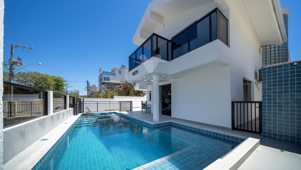 A modern two-story building with a swimming pool.