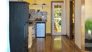A kitchen with wooden beams, a chandelier, and a refrigerator. - Turtle Beach Sanctuary Utila  (Isla de Utila)
