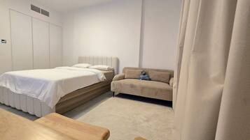 Luxury Studio, Courtyard View | Desk, laptop workspace, blackout drapes, soundproofing