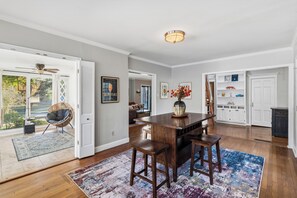 A spacious kitchen with a wooden island, white cabinetry, and a view of the outdoors. - 3-Bdrm Steps from Rhodes College, Near Zoo w/ Best Backyard and Upstairs Loft (Memphis)