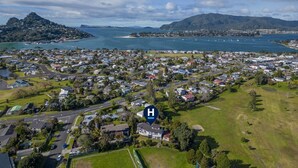 An aerial view of a coastal town with a hospital symbol indicating a hospital nearby.