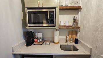 Fridge, microwave, coffee/tea maker, cookware/dishes/utensils