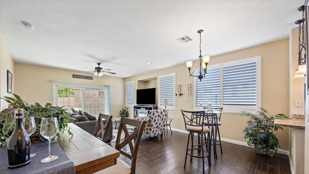 A spacious dining area with a long table, chairs, and a ceiling fan. - Stay with the Shay’s (Phoenix)
