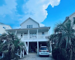 A two-story house with a covered front porch and a garage. - A Bit O Heaven - 1 Minute to the beach on private road (Oak Island)