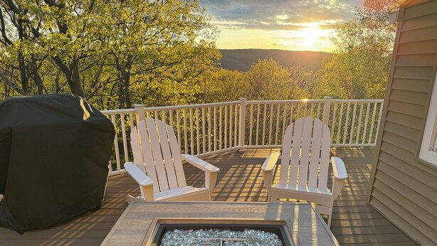 A deck with Adirondack chairs, a fire pit, and a grill. - 3 Bedroom Dream: Hudson Valley views, Woodbury Commons, West Point & Storm King (Cornwall)