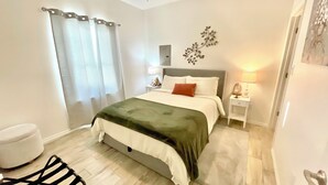 A bedroom with a bed, a nightstand, a lamp, a ceiling fan, and a window with curtains. - Peaceful 2-bedroom townhome -Sleeps 6 in La Feria (La Feria)