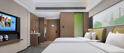 A modern hotel room with a large bed, a TV on the wall, and a cityscape painting.