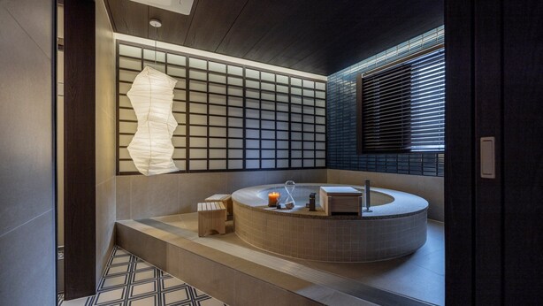 A modern bathroom with a freestanding bathtub, a large paper lantern, and a window with blinds. - Stay Passport Okinawa Ryokan Bupyeong Incheon (Incheon)