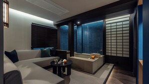 A modern living room with a sofa, a coffee table, and a small seating area with cushions. - Stay Passport Okinawa Ryokan Bupyeong Incheon (Incheon)
