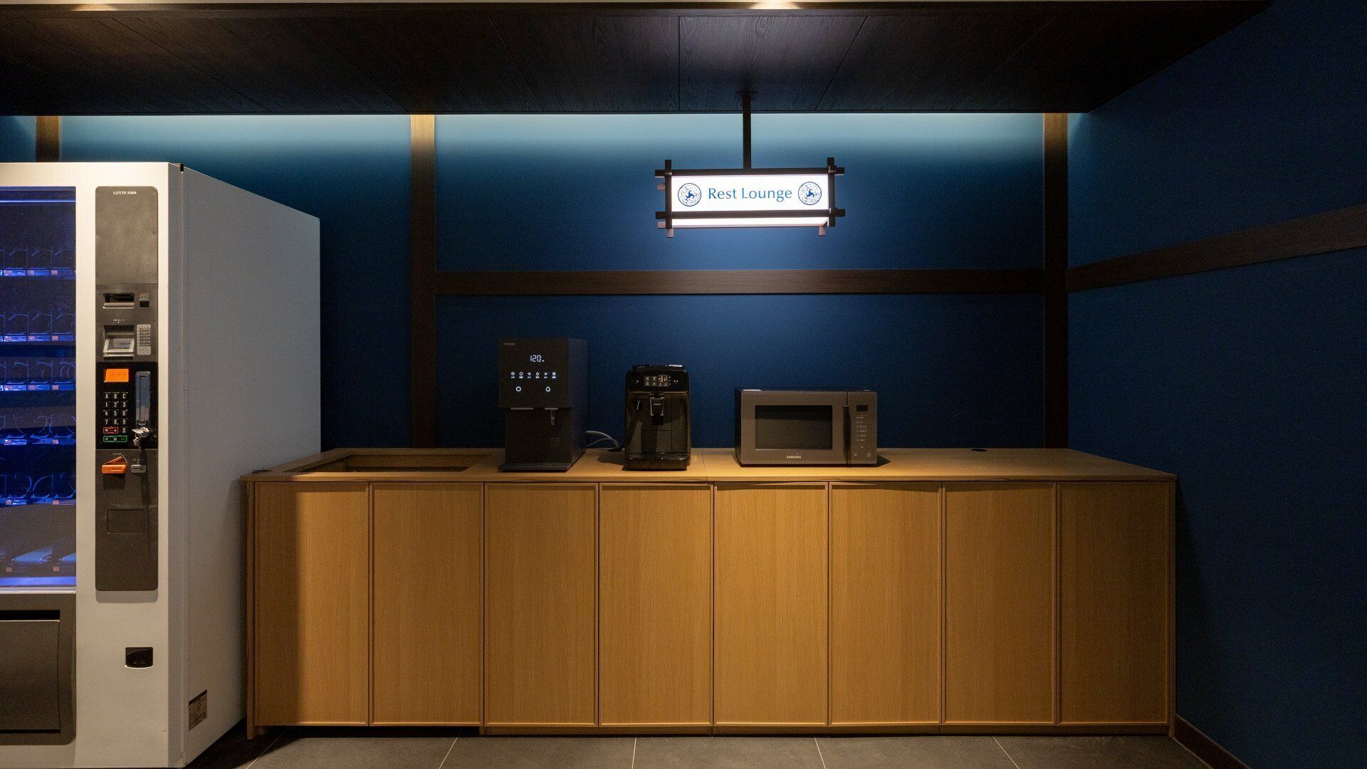 A rest lounge area with a coffee machine, microwave, and a vending machine.