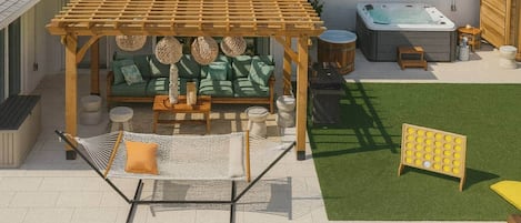 A backyard with a pool, a wooden pergola, a hot tub, and outdoor seating.