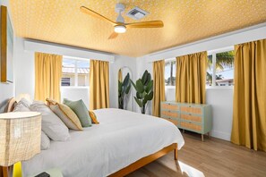 A bedroom with a bed, a ceiling fan, a dresser, and curtains. - Wellness Retreat at WPB - HotTub | Sauna | ColdPlunge | Golf (West Palm Beach)