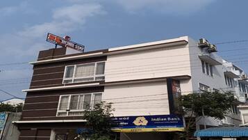 A multi-story building with a sign for 'SK Home Stay' on the top.