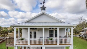 A two-story white house with a balcony, a chimney, and a weather vane. - Riverbend Landing - Steinhatchee (Steinhatchee)