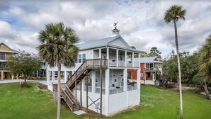 A two-story house with a balcony, a staircase, and a satellite dish. - Riverbend Landing - Steinhatchee (Steinhatchee)