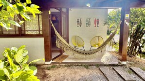 A hammock under a pergola with a door, a doormat, and fish wall art. - Entire home in Florianópolis, Brazil near Lagoa, Mole and Joaquina (Lagoa da Conceição)