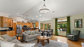 A spacious living room with a sofa, coffee table, and dining area.