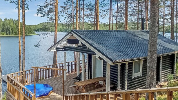A cabin with a deck, a covered porch, and a small pool. - Villa norppa by Interhome (Punkaharju)