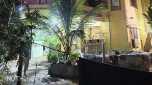 A multi-story building with balconies and a well-lit entrance. - Mauli cottage (Murud)