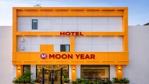 A hotel named 'Moon Year' with a prominent 'HOTEL' sign, a modern facade, and a series of potted plants at the entrance. - Hotel Moon Year (Lucknow)