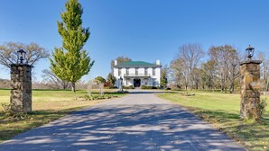 A large, stately building with a green roof, a central entrance, and a paved driveway leading to it. - Walk to Golf Course: Spacious Rough River Retreat! (Falls of Rough)