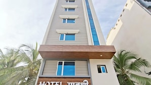 A modern hotel building with a sign reading "HOTEL MAHESRI". - Matrushree Hotels - Near Shree Dwarkadhish Temple (Dwarka)