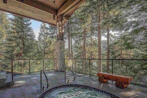 A wooden deck with a metal railing, surrounded by trees. - Mountain living, over 1400 sqft condo in Blueberry Hills, exceptional outdoor space, book for Summer (Whistler)