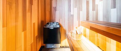 A sauna room with wooden walls and a bench.