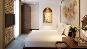 A modern bedroom with a large bed, a flat-screen TV mounted on a brick wall, a ceiling fan, and a decorative wall piece. - Villa de May Hoi An (Thanh pho Hoi An)