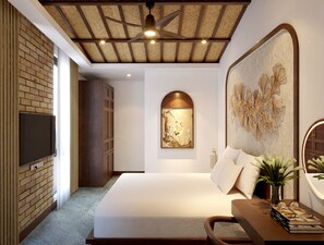 A modern bedroom with a large bed, a flat-screen TV mounted on a brick wall, a ceiling fan, and a decorative wall piece. - Villa de May Hoi An (Thanh pho Hoi An)