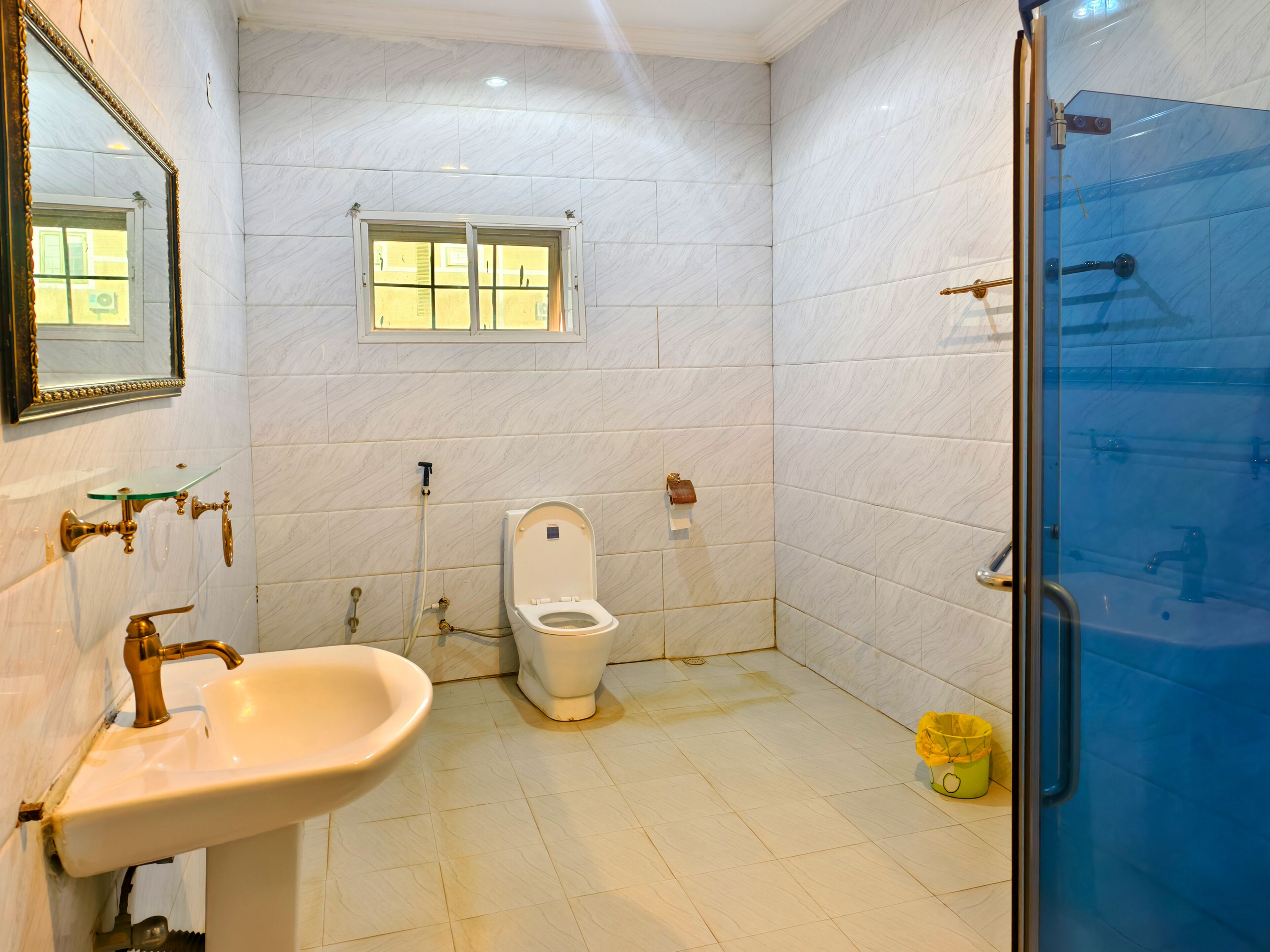 A bathroom with a toilet, sink, and shower.