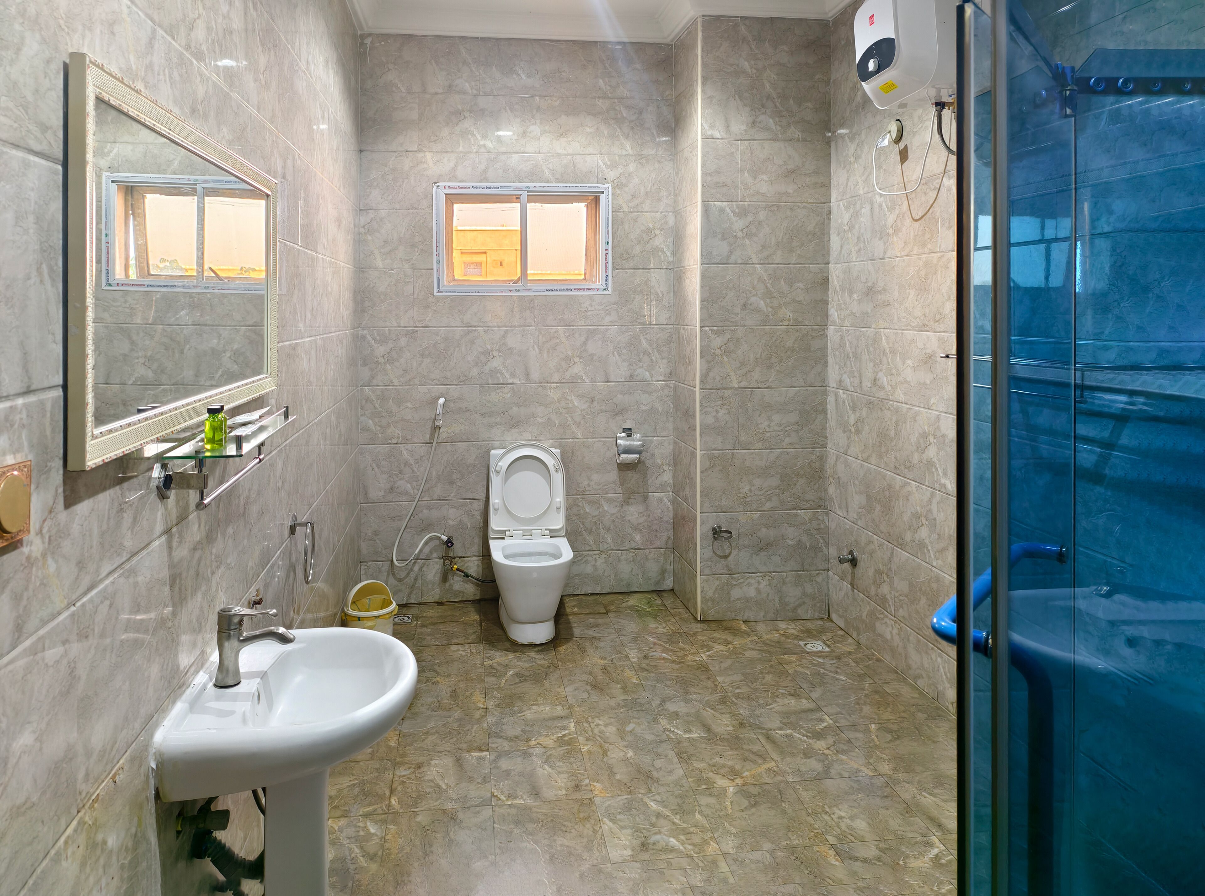 A bathroom with a sink, toilet, and shower.