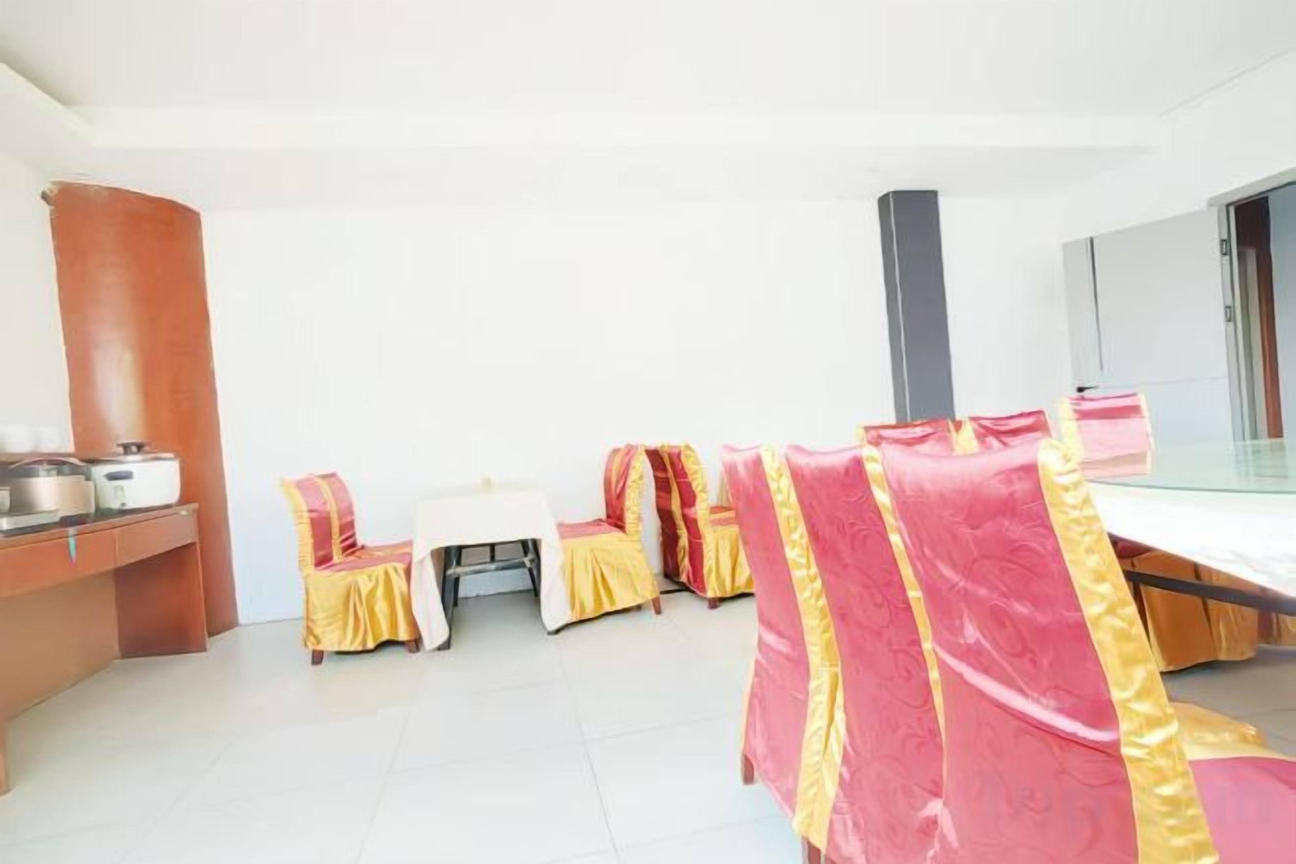 A hotel room with a bed, a desk, and a chair. There is a window and a door.