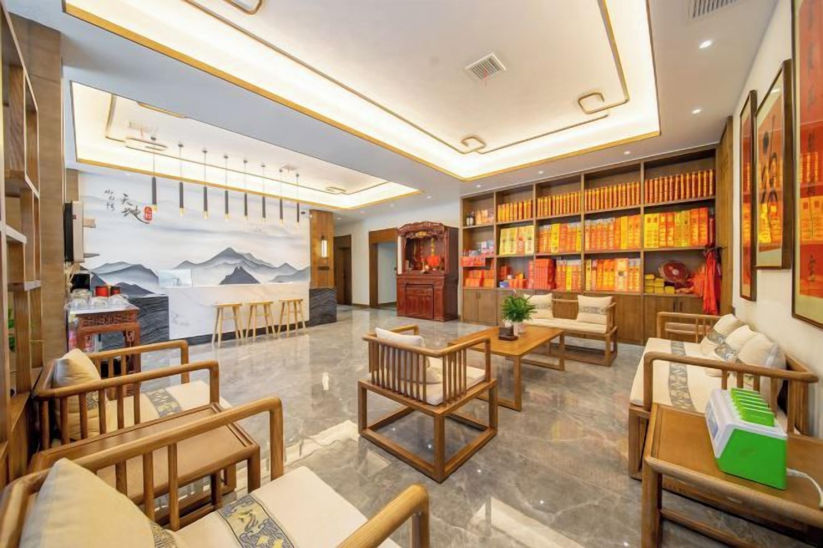 A hotel lobby with seating areas, a bar, and a bookshelf with books.